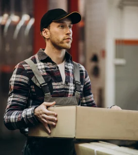 Delivery man holding a package for land transport logistics service